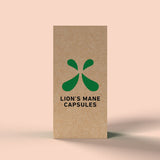 Side of Green Roads Lion’s Mane Capsules box featuring a green symbol and black product lettering on a peach background.
