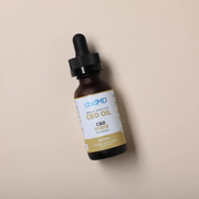 CBDMD 3000mg CBD Tincture bottle sitting on a brown background