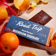 Road Trip Desert Stardust Mushroom Chocolate Bar - Dark Chocolate Orange — chocolate packaging with orange slices and strawberries.