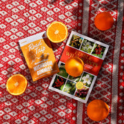 Road Trip Microdosed Mushroom Gummies — an orange gummy pouch beside oranges and photographs.