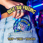 Hand with blue nails tucking a Ferris Wheel pouch into a denim pocket, with blue and purple party lights behind.