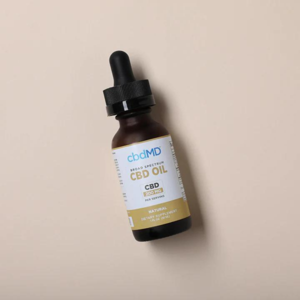 CBDMD 3000mg CBD Tincture bottle sitting on a brown background
