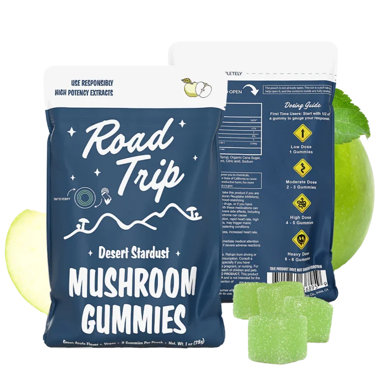 Road Trip Green Apple Mushroom Gummies pouch with floating green apple slices and gummies on a bright orange-yellow background.