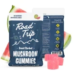 Road Trip Watermelon Mushroom Gummies pouch displayed with sliced watermelon and bright pink cube-shaped gummies.