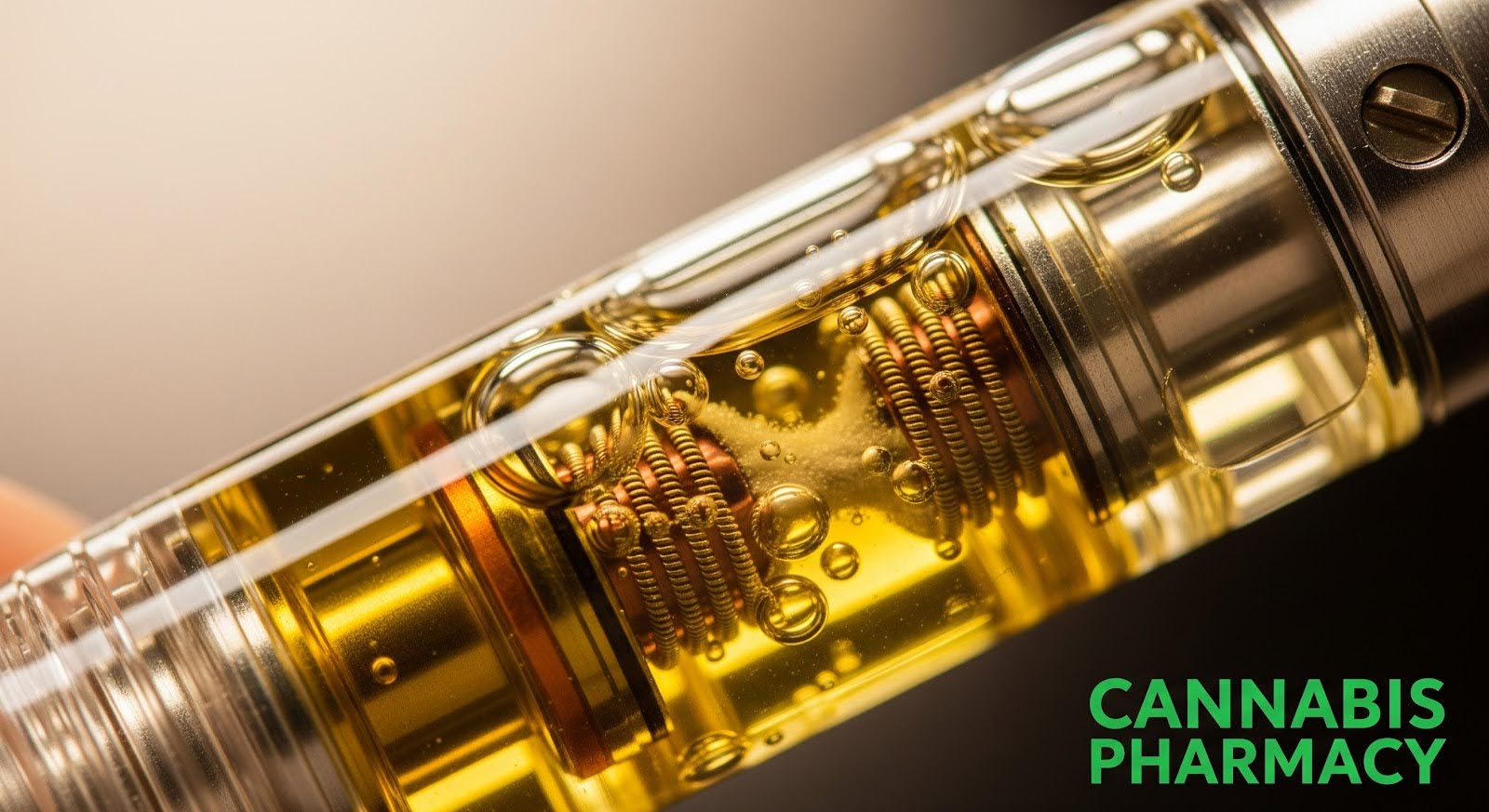 A detailed close-up of a cannabis vape pen cartridge filled with golden oil, clearly showing the internal metal coils and bubbles within the liquid. The metallic parts of the cartridge are sharply focused, and the text “Cannabis Pharmacy” appears in green at the bottom right.